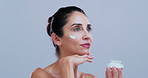 Thinking, cream and woman in studio for skincare, anti aging benefits and cosmetics for hydration. Dermatology, space and person with lotion jar for beauty, wellness and collagen on white background