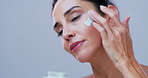 Face cream, mature and woman in studio for skincare, anti aging treatment and cosmetics for facial. Spa, space and person with lotion for beauty, dermatology and skin hydration on white background