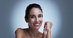 Face, mature woman and smile in studio with skincare for collagen, retinol and anti aging benefits. Confident, happy and female person with beauty, dermatology and smooth skin on grey background.