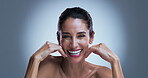 Face, woman or laughing in studio with skincare for wellness, collagen or anti aging benefits. Mature, happy or female person with spotlight for beauty, smooth skin or dermatology on gray background.