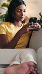 Phone, woman and relax on sofa with smile for weekend, typing and social media in lounge. Gen Z, girl and student with app for communication, texting or video for university break in living room