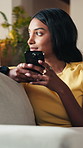 Phone, woman and thinking on sofa with smile for weekend, typing and social media in lounge. Gen Z, girl and student with app for communication, texting or video for university break in living room