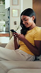 Couch, smile and woman typing with phone, social media update and online communication notification. Mobile app, funny message and person texting in home for entertainment, game website and blog post