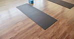 Above, fitness and mat in gym on floor, preparation and equipment for body wellness class. Start, empty room and setup in studio with support blocks, workout group or beginning of yoga session.