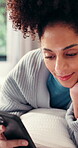 Relax, phone and reading with woman in home for social media, communicate and connection. Online chat forum, contact and profile update with person in apartment for notification, app and scroll