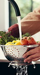 Hands, washing and vegetables in kitchen with water for meal prep, fresh food and healthy nutrition. Person, ingredients and cleaning for dirt removal, bacteria prevention or cooking hygiene in home.