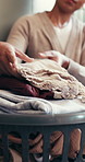 Hands, person and folding laundry for hygiene, organise fabric and clean linen. Woman, sorting clothes and washing garment for housework maintenance, domestic chores and housekeeping routine at house