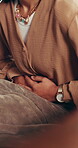 Hands, woman and massage stomach ache for period pain relief, menstrual cycle and endometriosis. Cramps, bloating and person rubbing sore abdomen in home, gastro and constipation for tummy problem.