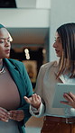 Lobby, business women and meeting with tablet for team, discussion and feedback with schedule. People, convention center and communication with social media, event review or venue website on walk