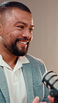 Podcast, smile or man in studio with microphone, discussion or personal story in streaming show. Talking, digital or male influencer in booth with equipment, announcement or sharing idea for content.