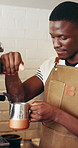 Black man, barista and steam milk in coffee shop for customer service, recipe and heating process. Waiter, machine and hospitality in startup cafe for menu item, order and hot beverage in restaurant