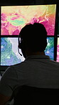 Computer screen, research and map with man in control room for climate data analyst, pressure and monitor. Meteorologist, rocket sensor and mission report with back of person for weather forecast