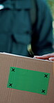 Logistics, tracking markers and green screen on box with delivery, chromakey and shipping of ecommerce stock. Cargo, distribution and courier outside in closeup, mock up and giving of package at home
