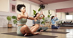 Women, yoga class and namaste on floor at gym with breathing, eyes closed and awareness with zen. People, group meditation and together with mindfulness, routine or peace on mat for wellness at club