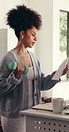 Woman, dumbbell and standing desk for remote work form home, exercise and review paperwork. Person, virtual assistant and freelancer with multitasking, fitness or documents for project management