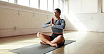 Yoga mat, prayer hands and woman in studio for wellness, mindfulness and breathing exercise for calm. Meditation, morning and person with peace on floor for health, balance and holistic healing