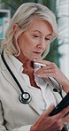 Thinking, doctor and woman with tablet for clinic schedule, healthcare report or telehealth. Tech, medical expert and mature person problem solving, reading email and planning research in hospital
