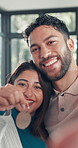 Face selfie, keys and smile of couple hug in new home together for growth, investment or mortgage. Love, moving house and photograph with people embracing in apartment for property or real estate