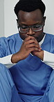Black man, surgeon and sad on floor at hospital with patient casualty, burnout and mental health. African person, medical professional and stress with depression, bad news or mistake at clinic