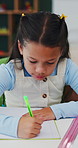 Homework, learning and writing with girl student at desk in home for assessment or distance education. Development, notebook and study with child learner in apartment for academics or knowledge