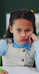 Girl, child and bored face with homework, book and writing notes with learning disability at house. Kid, portrait and notebook for education, study or frustrated for assignment at apartment in Mexico