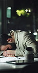 Night, sleep and tired businessman in office with burnout, deadline pressure or exhausted. Nap, workaholic and employee rest on desk with fatigue in corporate workplace, dream and person with bokeh
