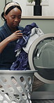Home, laundry and black woman with basket, machine and chores with routine, clothes and fabric. Apartment, housekeeping and African person with spring cleaning, linen and disinfection with appliance
