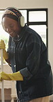 Headphone, singing and happy woman with broom in home, floor maintenance or listening to music. Flare, spring cleaning or black person sweeping with audio tech,  streaming or housekeeping for hygiene