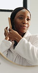 Mirror, bathroom and black woman with hairbrush in home for grooming, hygiene and wellness. Cosmetic, morning routine and person with reflection for beauty, self care and healthy texture for growth