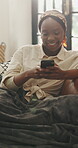 Texting, laugh and black woman on sofa with phone, funny chat and meme reaction on social media. Smile, digital and girl in house with tech, online communication or message notification on app.