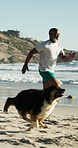 Senior black man, dog and running at beach with smile, exercise and fitness with bonding in summer. African person,  pet animal and excited with training, challenge or cardio by ocean in Nigeria