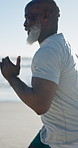Mature man, running and fitness on beach with exercise challenge for healthy body, goals and wellness. Active, black person outdoor and jog at ocean for cardio workout, endurance training or journey.