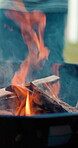 Barbecue, fire and wood with hands of friends outdoor for helping, social reunion and celebration. Bbq flames, lunch and support with people in backyard of home for weekend, holiday and cookout grill