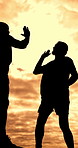 Help, high five and silhouette of people on mountain with sunset sky for adventure, hiking or journey. Assistance, climbing and travel with friends outdoor in nature together for trekking success