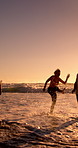 Senior man, friends and splash at beach, waves and kick water with space, games and bonding at sunset. Elderly people, group and excited with play, running or ocean with laugh outdoor in retirement