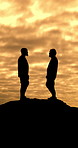 Hiking, silhouette and men with fitness, conversation and bonding together with sunset. Outdoor, hiker and healthy people with discussion, exercise and wellness with support, shadow and mountains