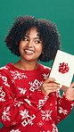 Christmas, shake gift and face of woman in studio for holiday, tradition and festive season. Happy, December and portrait of person with box for celebration, xmas or guess present on green background