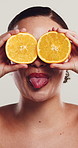 Woman, silly and orange in studio for skincare, natural treatment or vitamin C for dermatology. Person, citrus fruit or goofy on white background for organic care, healthy skin or antioxidants