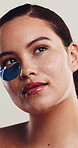 Skincare, face or woman with eye patches in studio, self care or dark circle treatment for wellness. Health, natural beauty or person remove mask for grooming, dermatology or glow on white background
