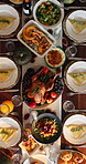 Thanksgiving, above and turkey on table in dining room for festive holiday, feast decoration and meal. Culture, season and roast dinner with chicken and spread in home for event, dishes and food