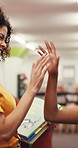 High five, teacher and child with hug in library for lesson success, literacy milestone or pride. Books, girl kid and tutor with embrace at school for learning support, education development or bokeh