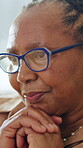 Memories, reflection and thinking with senior black woman in home for contemplation or recollection. Glasses, nostalgia and remember with thoughtful old person in apartment for retirement or wellness