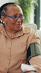 Blood pressure, healthcare and mature black woman on sofa in home living room for appointment. Checkup, medical and sphygmomanometer with senior African person in apartment for advice or consulting