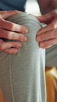 Knee pain, injury and hands of man in home for fibromyalgia, emergency and pressure crisis. Joint inflammation, osteoarthritis and sprain with person in living room of apartment for cramp and tension