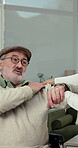 Shoulder pain, physiotherapist and holding hands with old man, checkup or muscle tension examination. Clinic, physical therapy and help for elderly patient with injury, rehabilitation and recovery