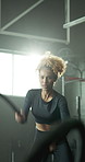 Woman, fitness and gym with battle rope for intense arm exercise, training or endurance. Active, female person or stamina with strong cable swing for strength workout, balance or grip in health club