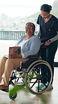 Assisted living, book and old woman in wheelchair with nurse for break, hobby or literature. Reading, retirement and senior patient with disability in home for recovery, rehabilitation or treatment