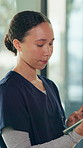 Nurse, woman or typing in hospital with tablet for patient information, medical research or admin. Caregiver, scroll or plan with tech in hospice with test results, healthcare records or digital app.