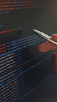 Programming code, hands and pen with computer screen for debugging, testing and app development. Programmer, person and closeup of tech display for data analysis, reading script and software update