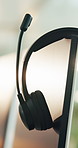 Computer, empty call center and headset in office for customer service, support and help desk. Equipment, business and mic on monitor in workplace for virtual assistance, crm hotline or contact us